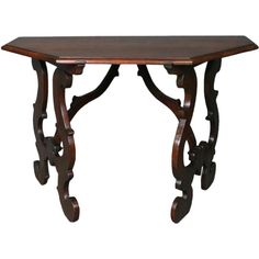 a wooden table with carved legs and a wood top on an isolated white background,