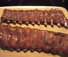 two large pieces of meat sitting on top of a cutting board next to each other