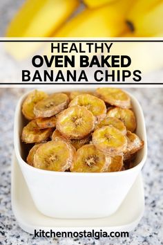 healthy oven baked banana chips in a white bowl on a granite countertop with bananas behind it