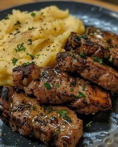 some meat and mashed potatoes on a plate