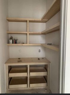 an empty closet with shelves and drawers