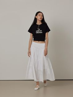 This product is a Cotton Cancan Tiered Long Skirt, meticulously designed to offer a flowing, feminine aesthetic. The skirt features multiple tiers that add volume and graceful movement with each step. Made from soft cotton, this piece ensures comfort and breathability, making it suitable for both casual and more dressed-up occasions. - The long skirt is structured with several layers, creating a full and dynamic silhouette that captures a romantic style.- Crafted from pure cotton, the fabric is both soft and lightweight, ideal for keeping cool during warmer months.- Its elastic waistband allows for a flexible fit, accommodating various body sizes comfortably.- The all-white color enhances its versatility, allowing it to be paired with a wide range of top styles and colors. Tiered Long Skirt, Long Tiered Skirt, Graceful Movement, Flowing Skirt, Feminine Aesthetic, Romantic Style, Body Size, All White, A Romantic