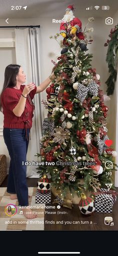 a woman decorating a christmas tree in her living room