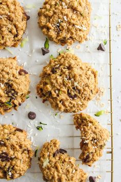 several cookies on a cooling rack with chocolate chips and sprinkled coconut flakes