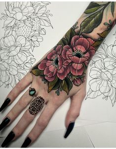 a woman's hand with flowers on it