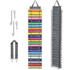 an assortment of different colored crayons hanging from hooks and clips on a white background