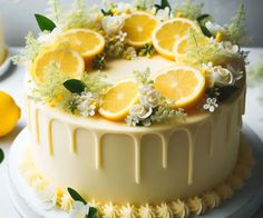 a white cake with lemons and flowers on top