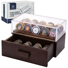 a display case with coins in it and an open box on the side that says challenge library