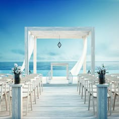 an outdoor wedding setup with white chairs and flowers