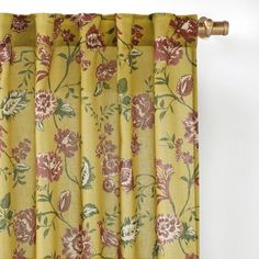 a yellow curtain with red and green flowers on it