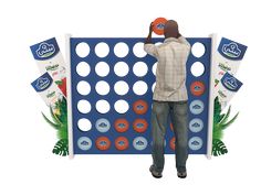 a man standing in front of a giant board game