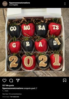 a box filled with chocolate covered strawberries in the shape of numbers and apples for new year's eve