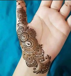 the hand is decorated with henna designs on it