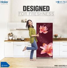 a woman standing in front of a refrigerator with flowers on the door and words designed for freshness