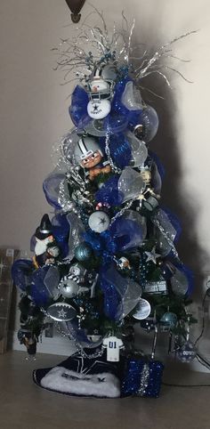 a christmas tree decorated with blue and silver ornaments