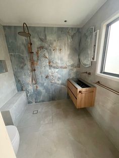 a bathroom with a sink, toilet and bathtub next to a window in it