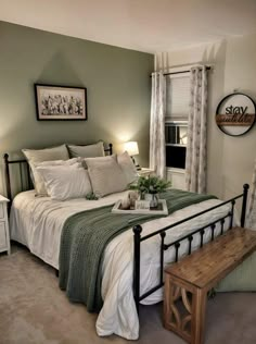 a bedroom with green walls and white bedding