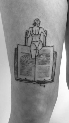 a person with a book tattoo on their leg