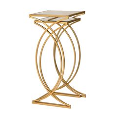 a gold metal and glass side table with two intersecting legs, one on top of the other