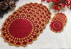 crocheted doily and placemats on a table with pine cones in the background