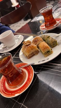 tea and pastries on plates with cups of tea