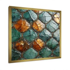 an art piece with green and gold glass tiles on it's side, hanging on a wall