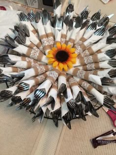 a sunflower is surrounded by forks and knives