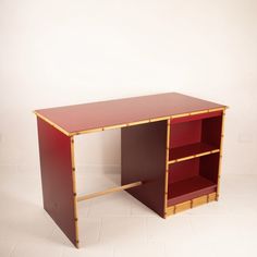 a red desk with two shelves on each side