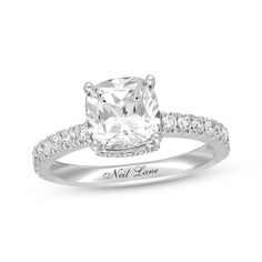 a cushion cut diamond engagement ring with pave set shoulders