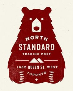 the north standard trading post logo with a bear on it's back and an arrow pointing