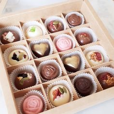 a box filled with assorted chocolates on top of a table