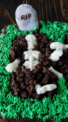 a halloween cake with green frosting and white icing on the top is decorated with sprinkles