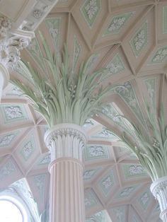 the interior of a building with columns and ceiling