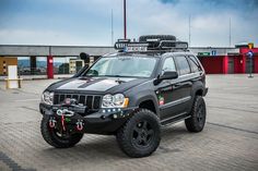 a black jeep parked in front of a building