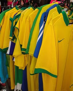 many soccer jerseys are hanging on the rack