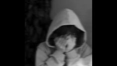 a person wearing a hoodie covering their face