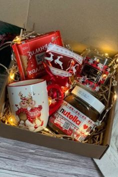 a box filled with lots of different types of food and condiments on top of a wooden table