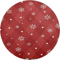 a red and white snowflake pattern on a round tablecloth with polka dots