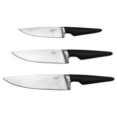 three knives sitting next to each other on a white surface