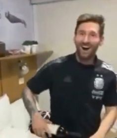 a man is laughing while standing in his room