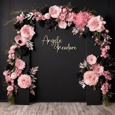 a black and pink wedding backdrop with flowers