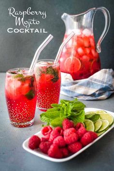 raspberry mojito cocktail with limes and mint garnishes