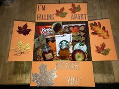 an orange box filled with fall items on top of a wooden table