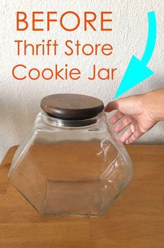 a person is holding a cookie jar on top of a table with the words before thrift store cookie jar