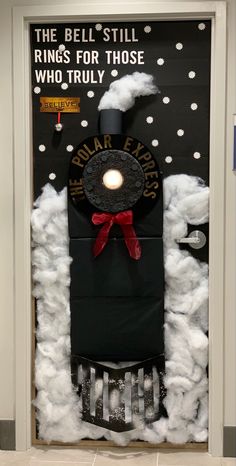 a door decorated to look like a train with clouds and snow around it, that says the bell - still rings for those who truly are truly