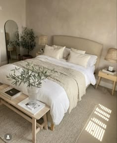 a bedroom with a bed, mirror and table in it