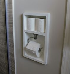 a toilet paper dispenser with two rolls of toilet paper on the wall