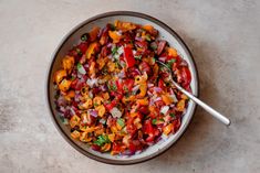 a bowl filled with chopped vegetables on top of a table