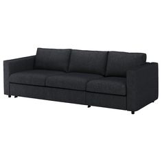 a black couch sitting on top of a white floor