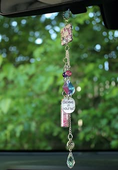 a car window hanging with some charms attached to it